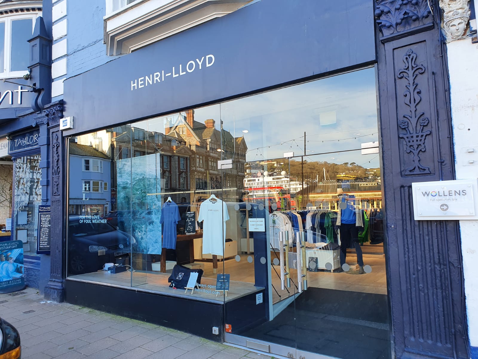 Henri-Lloyd storefront with navy fascia and cut white lettering above the shop window